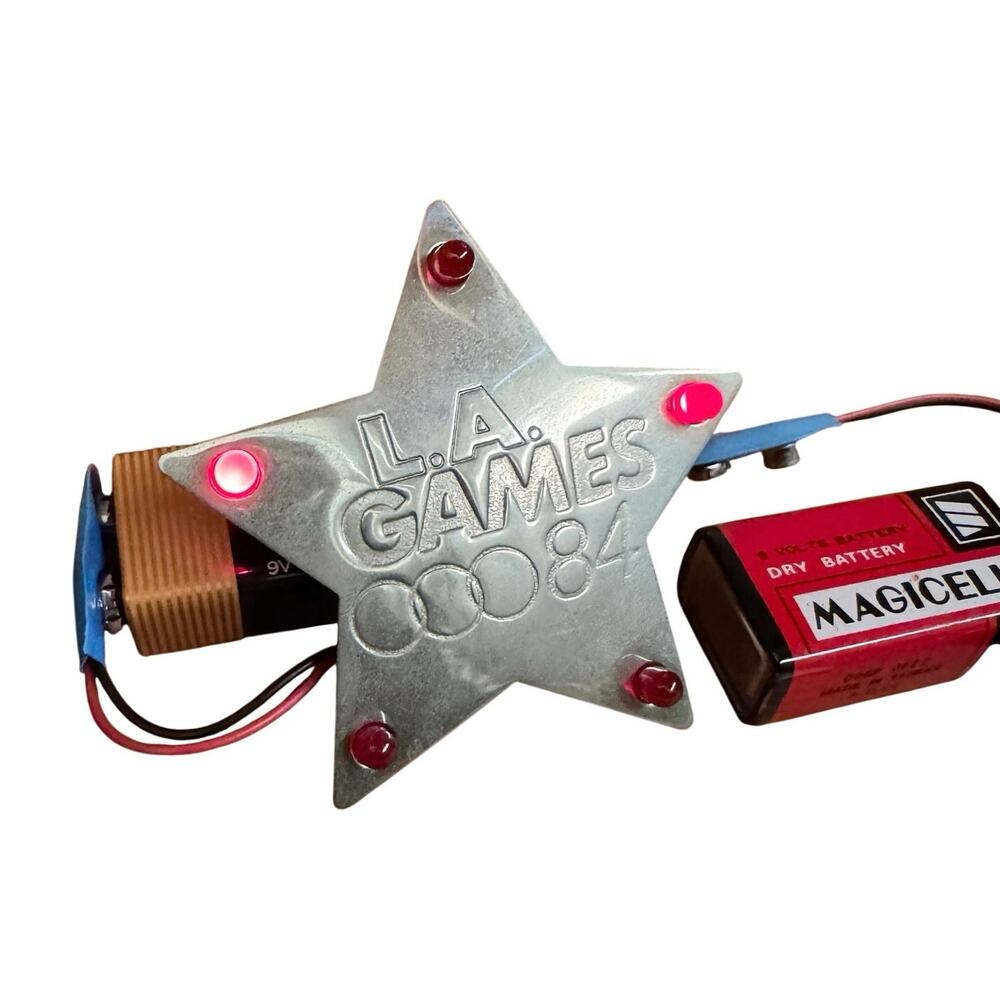 Vintage 1984 L.A. Games electronic star light up lapel pin by Gemtron. Tested